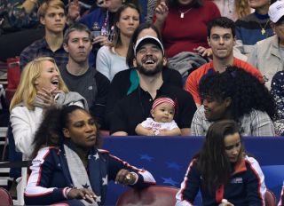 ASHEVILLE, NC - FEBRUARY 10: Serena Williams of Team USA, bottom left, along with her husband Alexis Ohanian and their daughter Alexis Olympia, center, watch the action during the first round of the 2018 Fed Cup at US Cellular Center on February 10, 2018 in Asheville, North Carolina