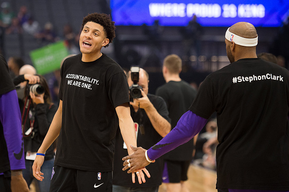 Sacramento Kings forward Justin Jackson (25) slaps hands with Sacramento Kings guard Vince Carter (15) as they wear T-shirts bearing the name of Stephon Clark during a game at Golden 1 Center on Sunday March 25, 2018 in Sacramento, Calif. The Kings and Celtics wore shirts bearing the name of the unarmed man, Stephon Clark, who was killed by Sacramento police. The black warm-up shirts have 