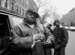 UNITED STATES - JANUARY 18: Rapper Notorious B.I.G., aka Biggie Smalls, aka Chris Wallace rolls a cigar outside his mother's house in Brooklyn.