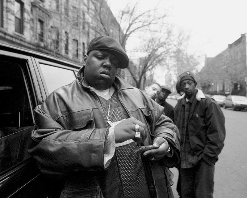 UNITED STATES - JANUARY 18: Rapper Notorious B.I.G., aka Biggie Smalls, aka Chris Wallace rolls a cigar outside his mother's house in Brooklyn.