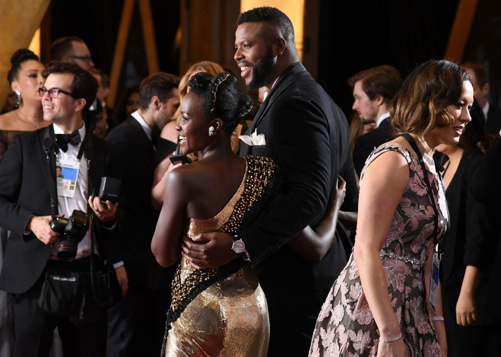 Kenyan actress Lupita Nyong'o (L) and Trinidadian actor Winston Duke arrive for the 90th Annual Academy Awards on March 4, 2018, in Hollywood, California.