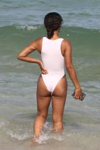 Christina Milian at the beach in Miami Beach, FL wearing a white tie up bikini by Myra Swim.
