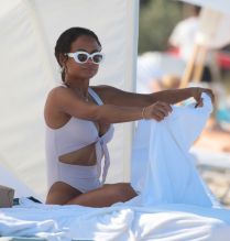 Christina Milian at the beach in Miami Beach, FL wearing a white tie up bikini by Myra Swim.