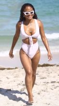 Christina Milian at the beach in Miami Beach, FL wearing a white tie up bikini by Myra Swim.