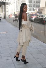 Actress and singer Ryan Destiny, star of FOX TV's 'Star', spotted leaving 'Good Day New York' wearing a khaki bustier top with pants that lace up in the rear leg, black mules with ankle ties, and a trench coat draped off the shoulder