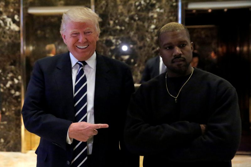  U.S. President-elect Donald Trump and musician Kanye West walk through the lobby at Trump Tower in Manhattan, New York City, U.S., December 13, 2016.