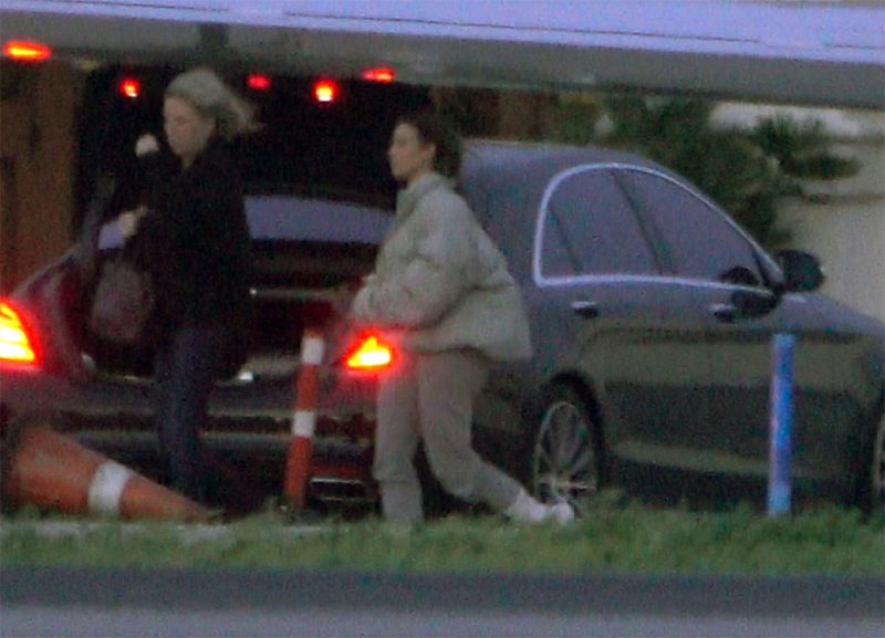 Kim Kardashian and rest of Kardashian family and Khloe Kardashian's friends arrive back in LA just hours after helping welcome her newborn baby girl in Cleveland. Kim was spotted with wind flowing in the hair as they had a bumpy landing upon arrival to LA.