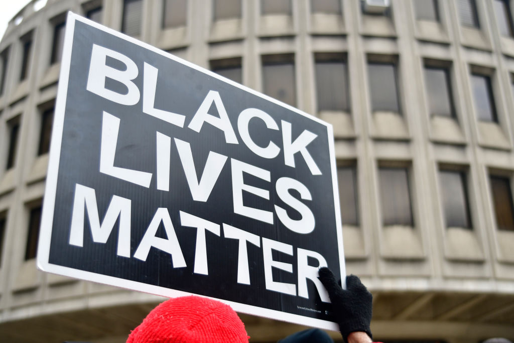 Black Lives Matter sign is held by a protestor participating as community members join religious leaders and clergymen with Philadelphians Organized to Witness, Empower and Rebuild (POWER) hold a Police Accountability rally, followed by a protest march starting at Philadelphia Police Dept. headquarters and ending at City Hall in center City Philadelphia, PA, on April19, 2018. The protest is a reaction to the recent controversial arrest at a Center city Starbucks of two black men.