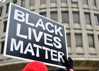 Black Lives Matter sign is held by a protestor participating as community members join religious leaders and clergymen with Philadelphians Organized to Witness, Empower and Rebuild (POWER) hold a Police Accountability rally, followed by a protest march starting at Philadelphia Police Dept. headquarters and ending at City Hall in center City Philadelphia, PA, on April19, 2018. The protest is a reaction to the recent controversial arrest at a Center city Starbucks of two black men.