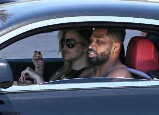Khloe Kardashian and Tristan Thompson pick up lunch at Mcdonalds drive-thru, Khloe was eating french fries as they pull out and Thistan said my girls got to eat