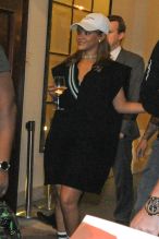 Rihanna seen arriving at her hotel in Warsaw, Poland with a glass of wine in hand. The singer paused to sign autographs for waiting fans before entering the building.