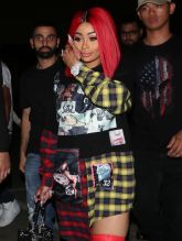 Blac Chyna proudly shows off her new red hair as she leaves the Ace of Diamonds club in Los Angeles, CA.