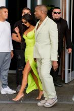 Kim Kardashian neon Versace gown Miami's Versace Mansion for rapper 2Chainz Wedding on Saturday (aug 18). Kanye West sage Louis Vuitton suit and sandals