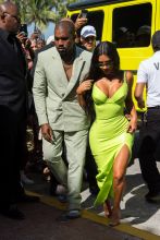 Kim Kardashian neon gown as she and Kanye West arrive at Miami's Versace Mansion for rapper 2Chainz Wedding on Saturday (aug 18).