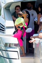 Kim Kardashian curves vintage hot pink Chanel onesie Miami boat trip. cute kids North and Saint, OG crew Jonathan Cheban and Larsa Pippen. Dave Grutman's 'Groot boat Larsa's daughter Sophia Pippen, ABC's Dancing With The Stars: Juniors.