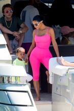 Kim Kardashian curves vintage hot pink Chanel onesie Miami boat trip. cute kids North and Saint, OG crew Jonathan Cheban and Larsa Pippen. Dave Grutman's 'Groot boat Larsa's daughter Sophia Pippen, ABC's Dancing With The Stars: Juniors.