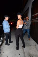 Draya Michelle REVOLVE store on Melrose in Los Angeles, CA. ample cleavage beige corset and black pants.