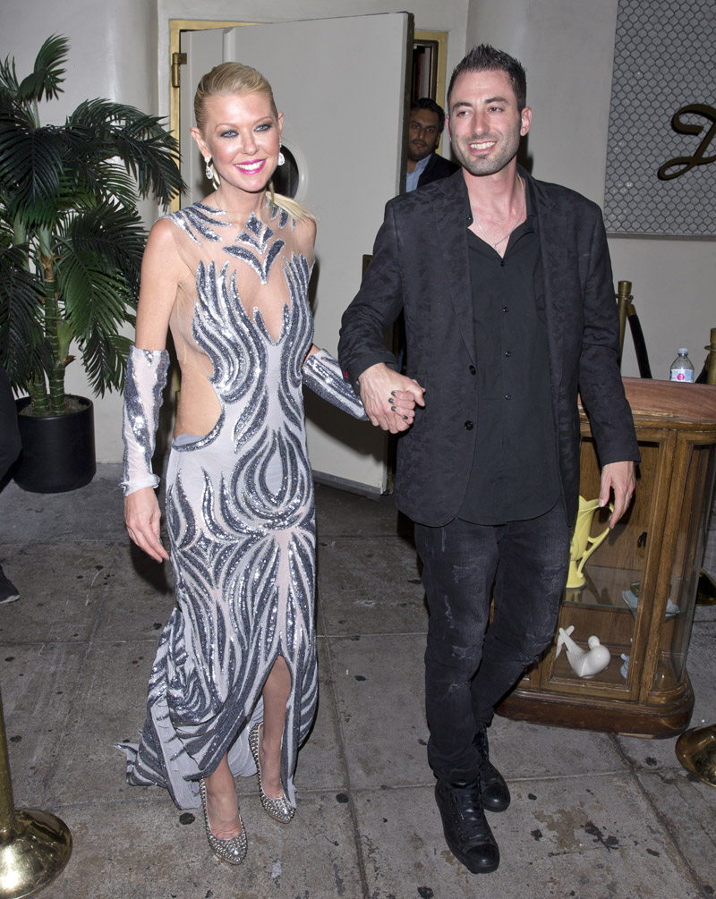 Actress Tara Reid seen at Delilah Night Club dressed in a Silver colored designer evening gown holding on the arm of her boyfriend. Tara has recently been promoting her latest installment of the movie 'Sharknado'