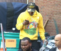 Travis Scott checks his phone while out and about in New York.