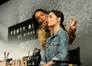 DUBAI, UNITED ARAB EMIRATES - SEPTEMBER 29: Rihanna applies make up on a model during her Fenty Beauty talk in collaboration with Sephora, for the launch of her new Stunna Lip paint "Uninvited" on September 29, 2018 in Dubai, United Arab Emirates.