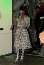 Kim Kardashian is seen leaving a private event wearing money print coat and boots at Delilah nightclub in Los Angeles, CA.