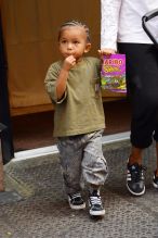 Saint West seen eating gummy candy while out with his nanny in SOHO NYC
