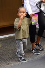 Saint West seen eating gummy candy while out with his nanny in SOHO NYC