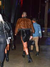 EJ Johnson wearing Fendi fur jacket and blouse with patent leather mini skirt and booties in Los Angeles, CA.