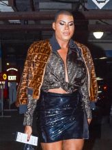 EJ Johnson wearing Fendi fur jacket and blouse with patent leather mini skirt and booties in Los Angeles, CA.