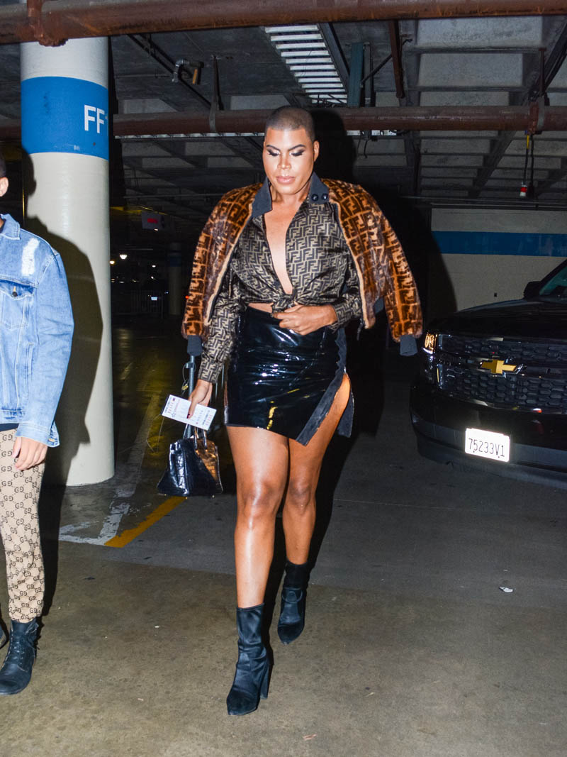 EJ Johnson wearing Fendi fur jacket and blouse with patent leather mini skirt and booties in Los Angeles, CA.
