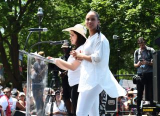 WASHINGTON, DC - JUNE 30: Alicia Keys and America Ferrera speak during Families Belong Together Rally In Washington DC Sponsored By MoveOn, National Domestic Workers Alliance, And Hundreds Of Allies on June 30, 2018 in Washington, DC.