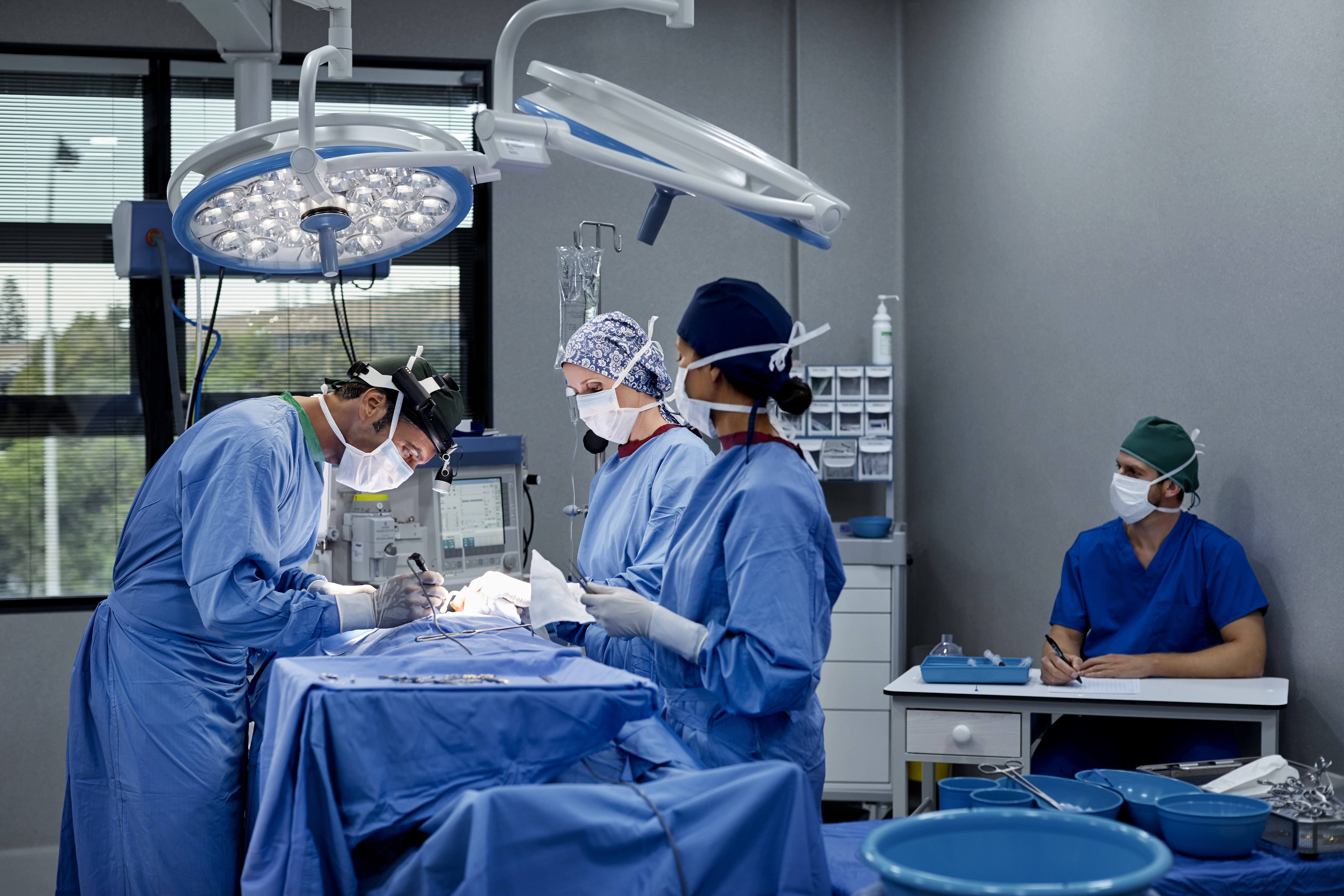 Surgeons operating patient in hospital