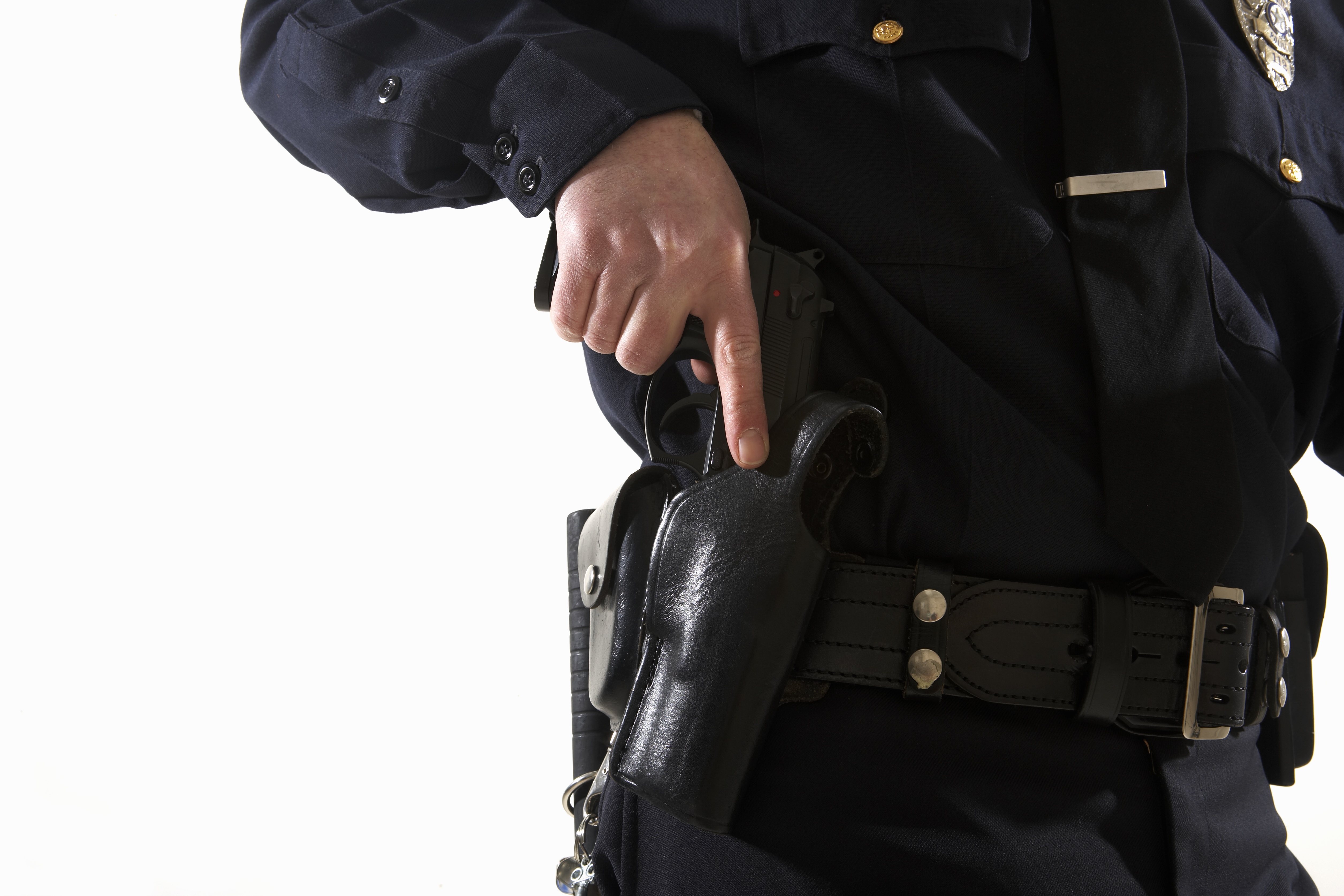 Male police officer reaching for his holster