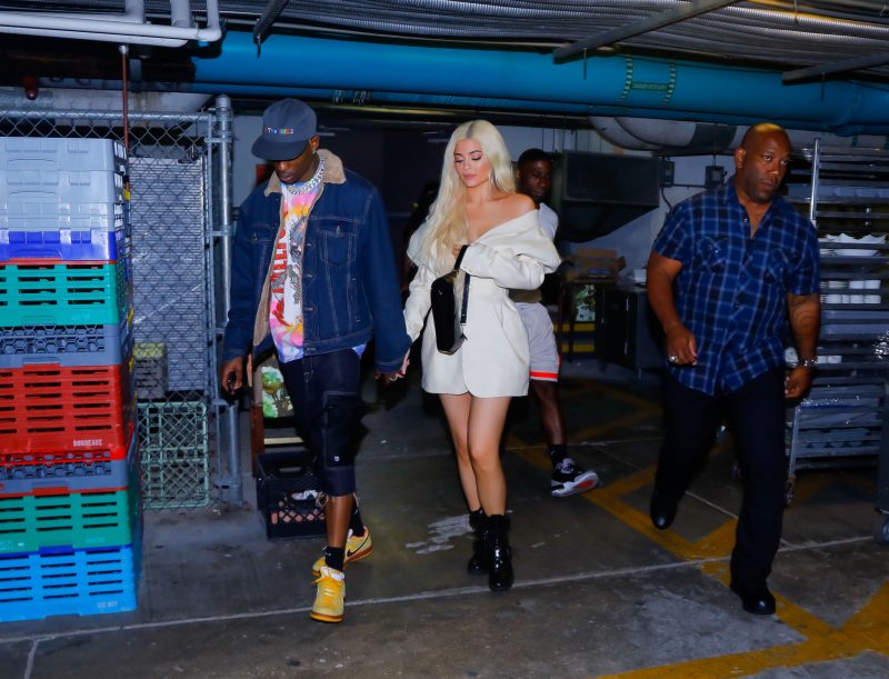 Kylie Jenner is all smiles as she exits the Nobu restaurant holding hands with her boyfriend Travis Scott on their date night during a break in the tour as the arrived into Miami Beach. Kylie was wearing a fashionable cream look as Travis was wearing some looks from his tour, Astroworld.