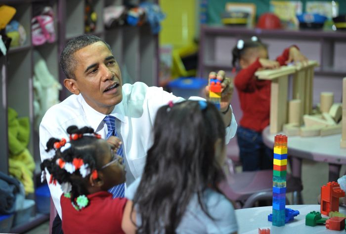 US President Barack Obama helps children