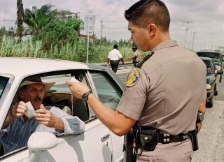 Florida State Trooper Peter Chord asks a Florida K