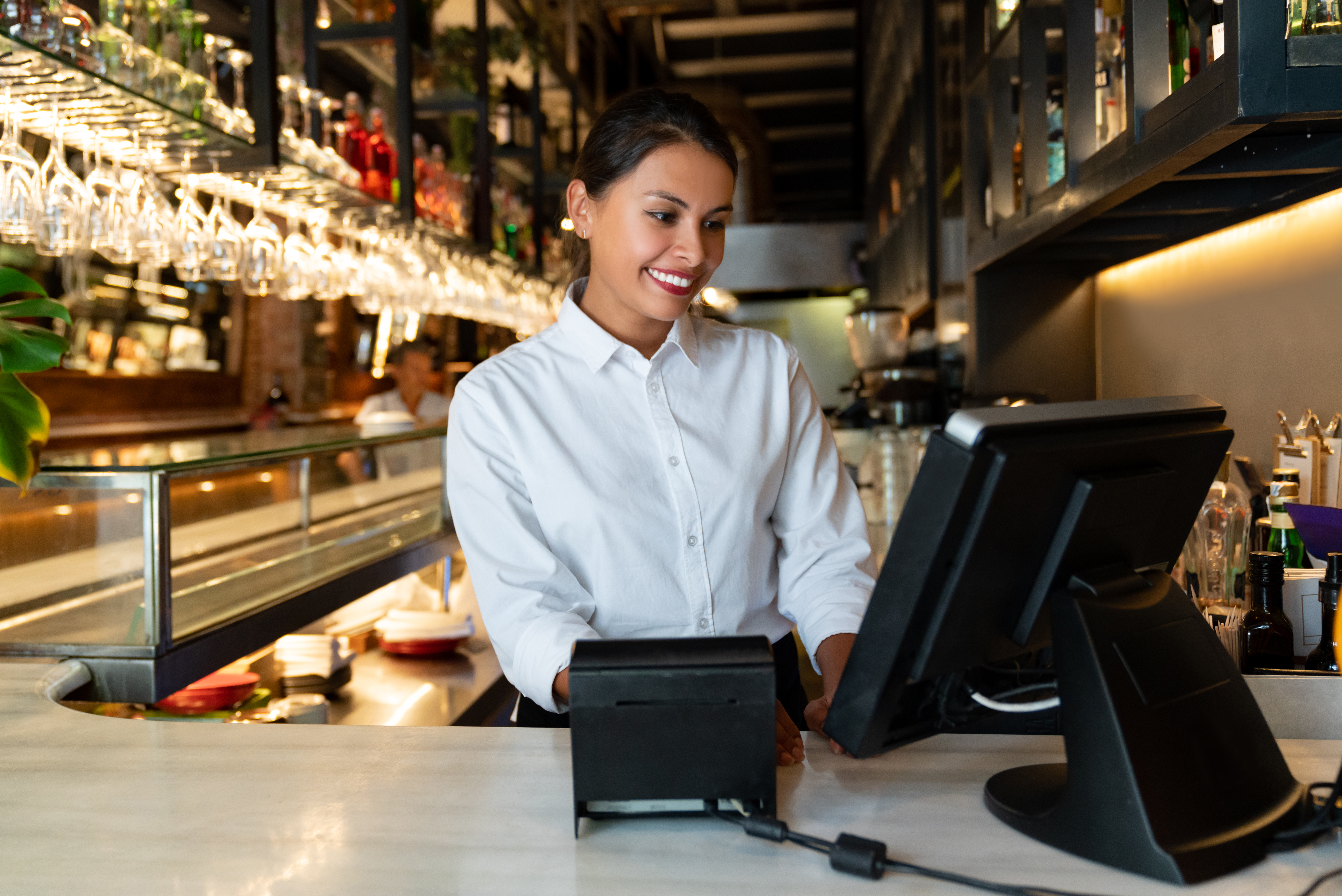 Woman working on the cashier at a restaurant