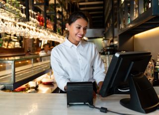 Woman working on the cashier at a restaurant