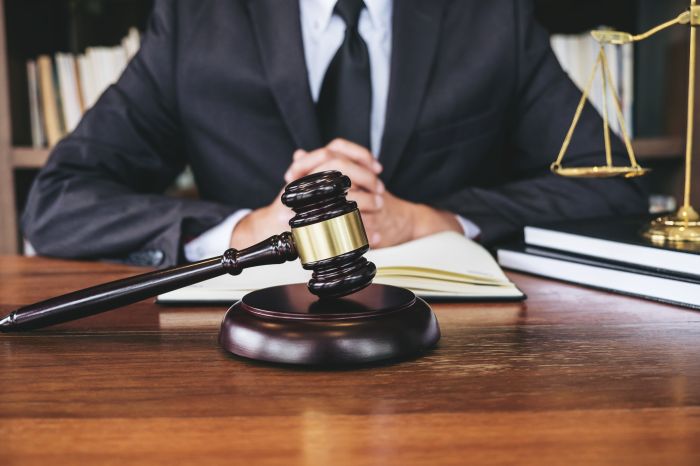 Midsection Of Judge Sitting At Desk