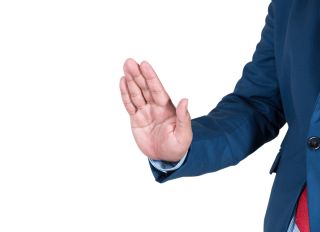 Cropped Image Of Businessman Showing Stop Gesture Against White Background