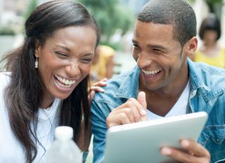 Close Up of Laughing Couple with Digital Tablet