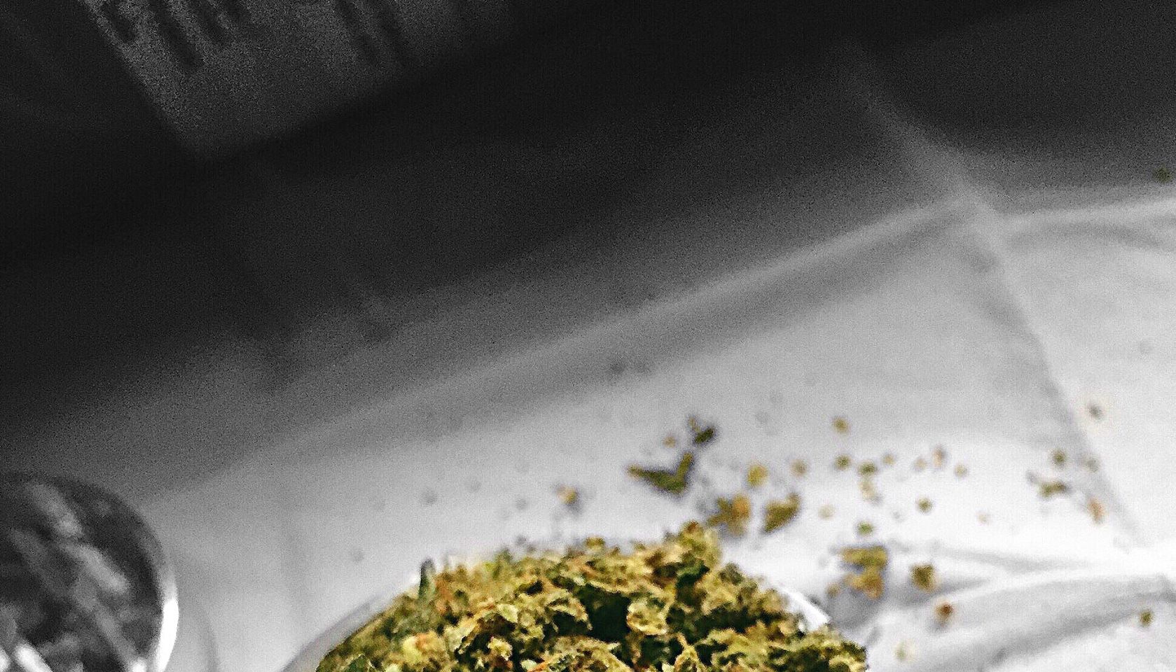 High Angle View Of Marijuana In Container On Table