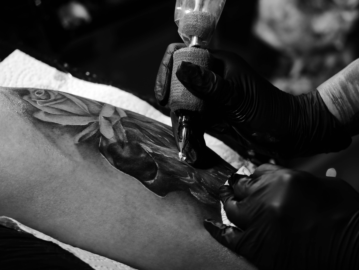 Cropped Image Of Tattooist Making Tattoo On Customer