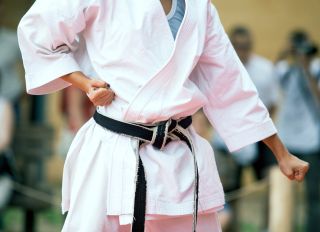 Midsection Of Child Practicing Karate