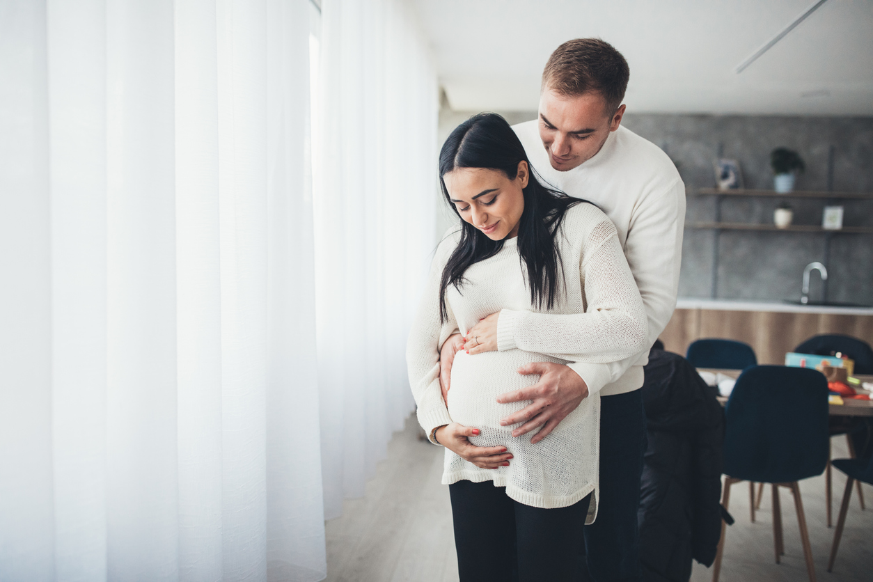 Parents touching pregnant belly