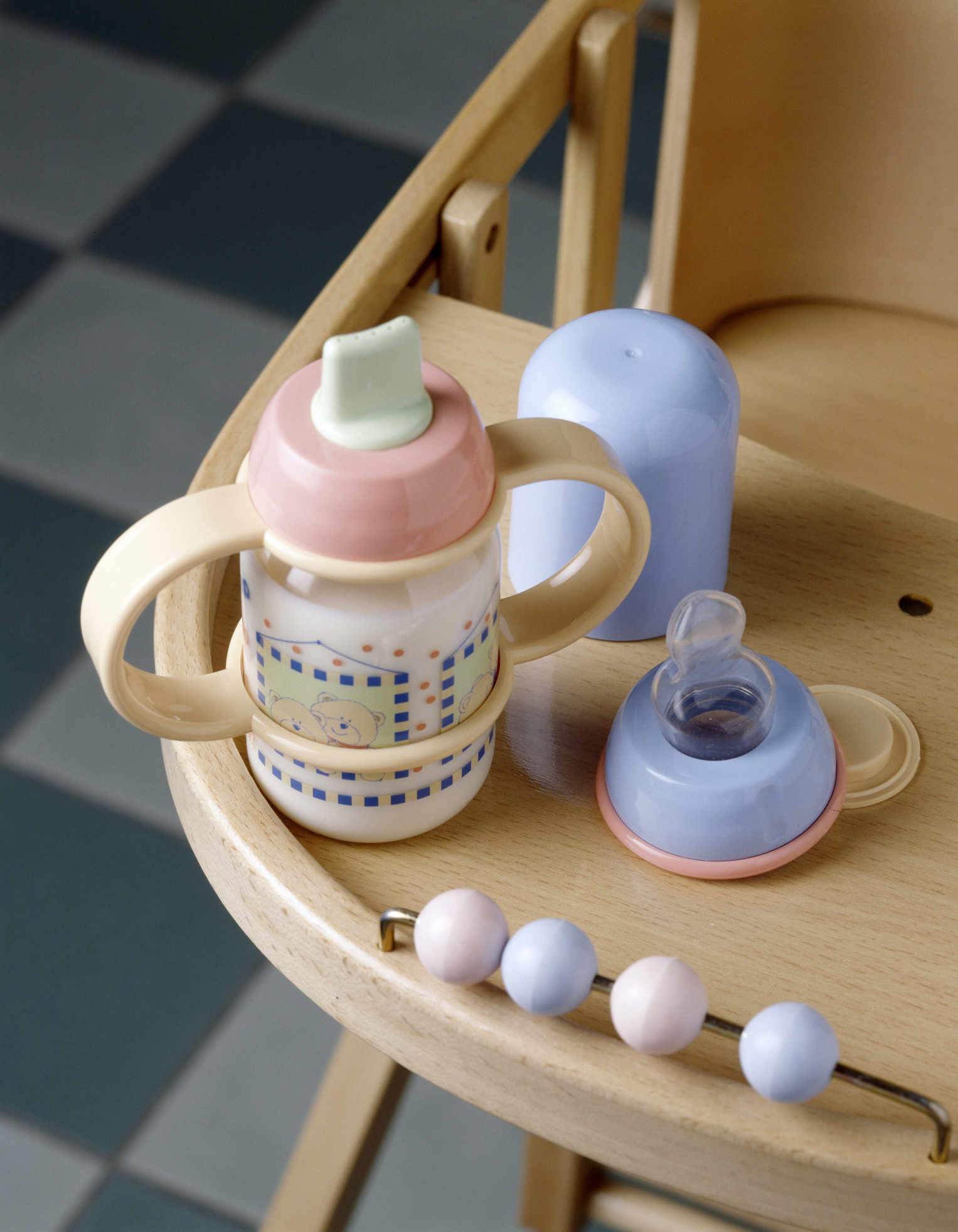 Baby bottle full of milk on a high chair