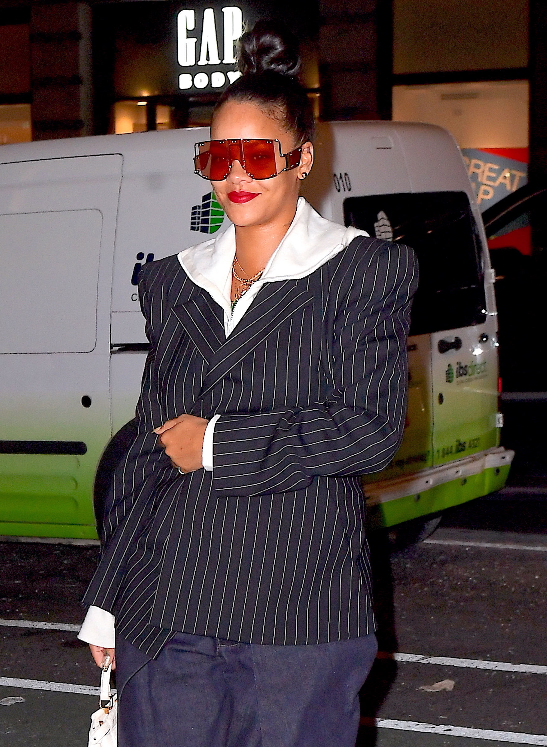 Rihanna wears pinstriped blazer with white hoodie
