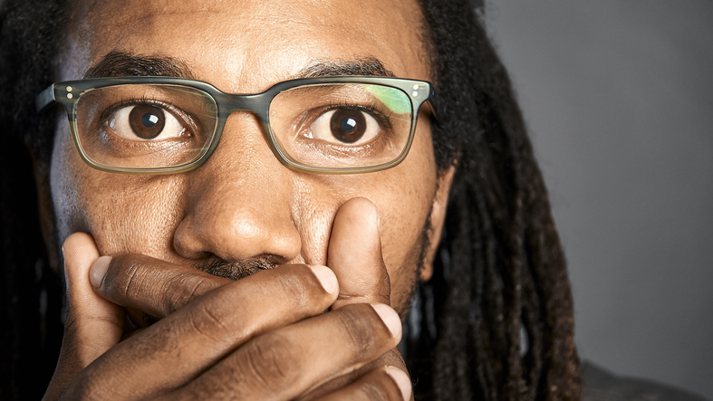 Man with a shocked expression, looking at something.