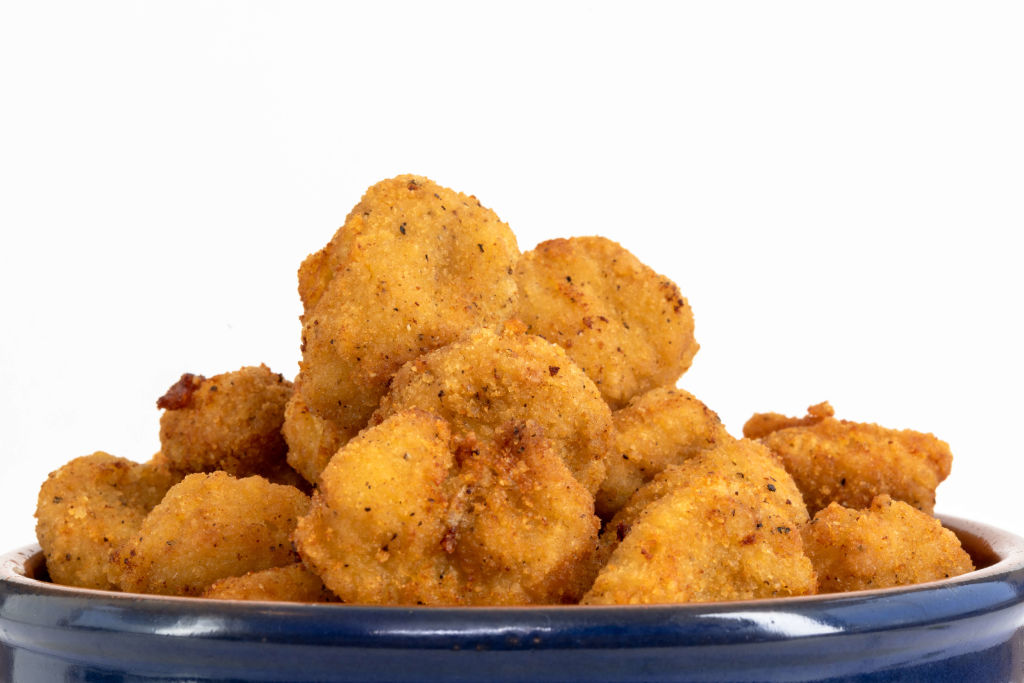 Close up of Chicken Nuggets over a white background. Healthy...