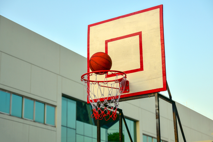 Basketball Over Hoop Against Clear Sky